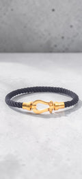 Pulsera de trenzado de titanio negro con herraje dorado pulido
