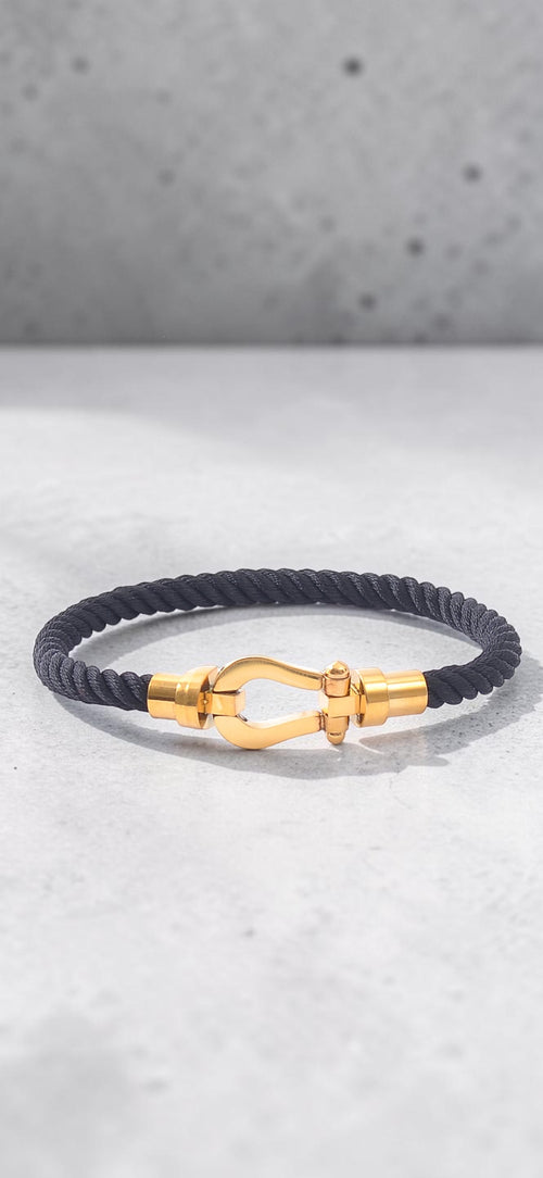 Pulsera de trenzado de titanio negro con herraje dorado pulido